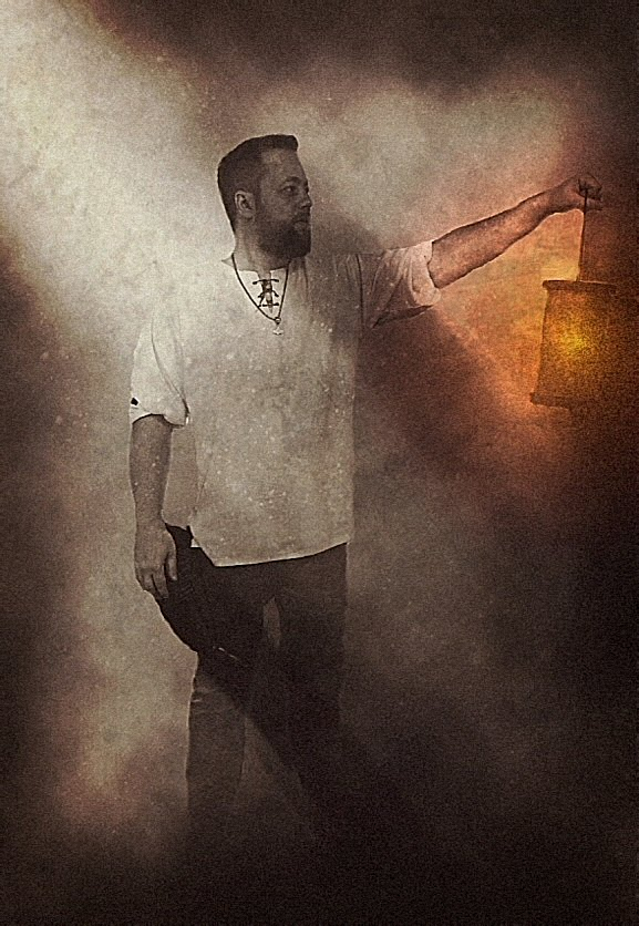 Danheim holding a lantern glowing through the mist